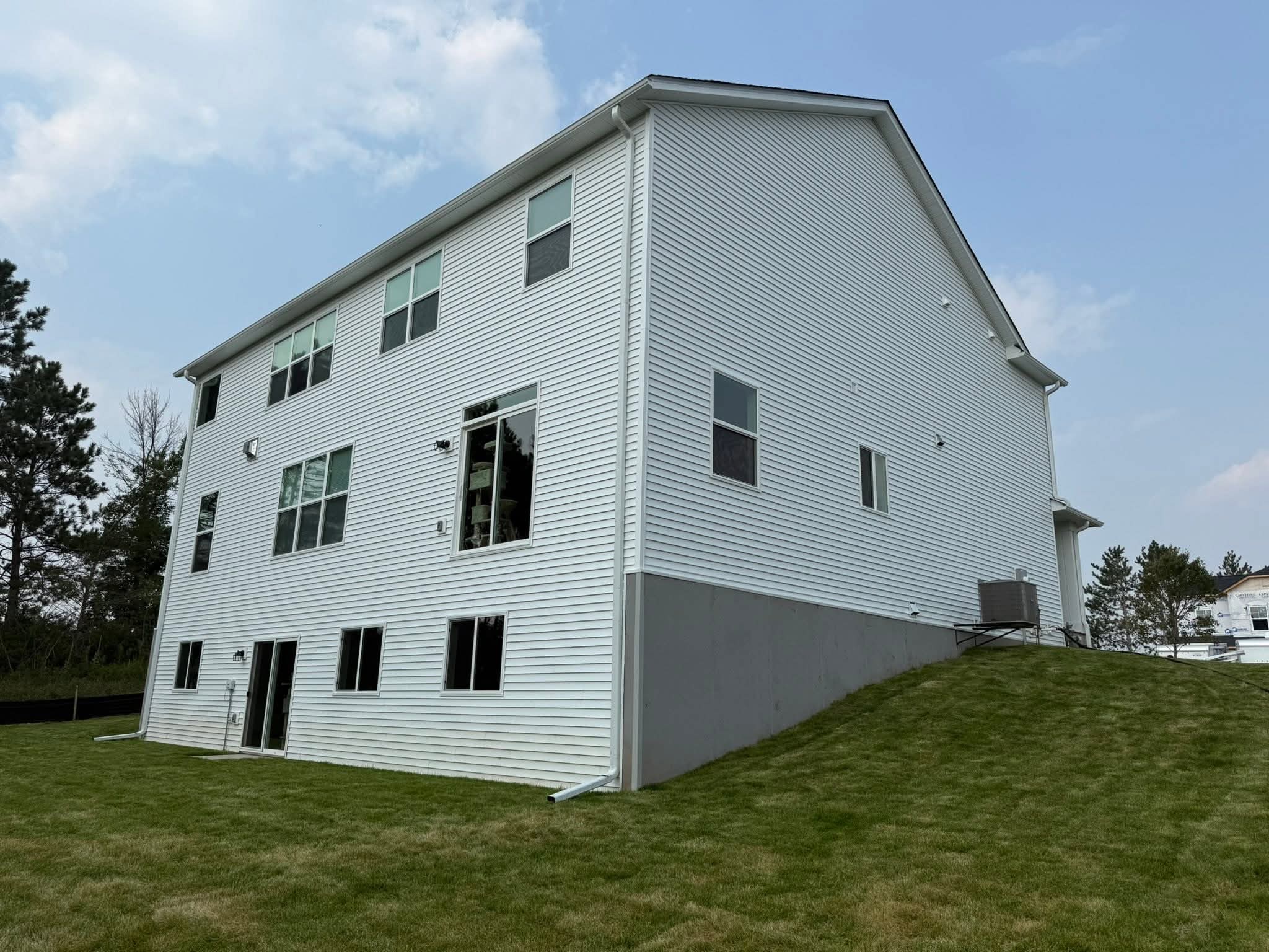 Gutter Craftsman crew installing seamless gutters on a Western Wisconsin home