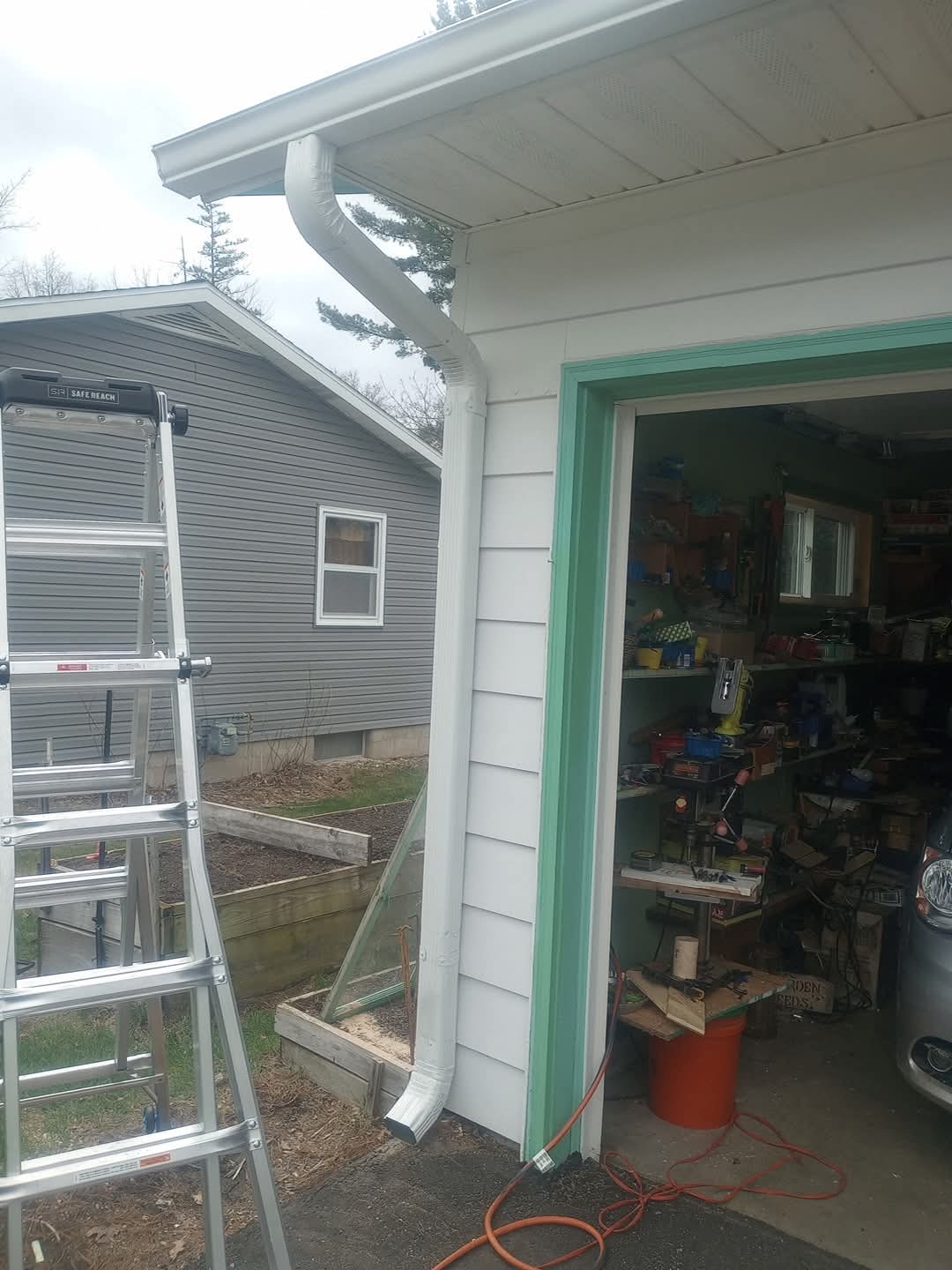 White garage gutter and downspout installation